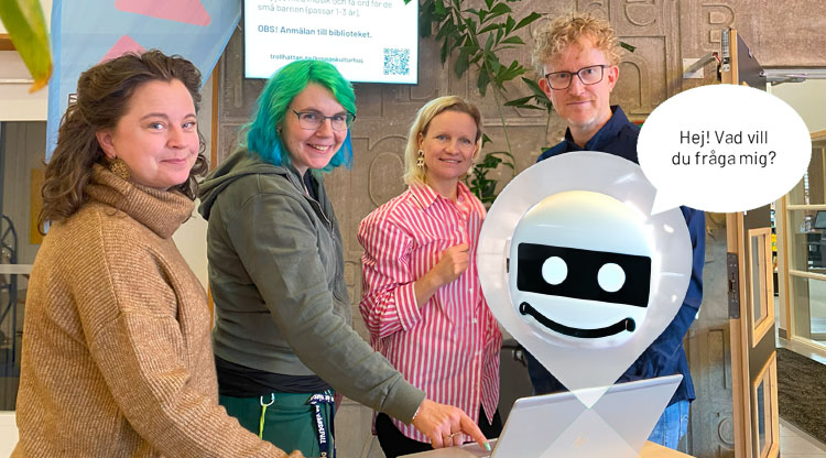 Fyra personer vid en dator och en illustration av en robot