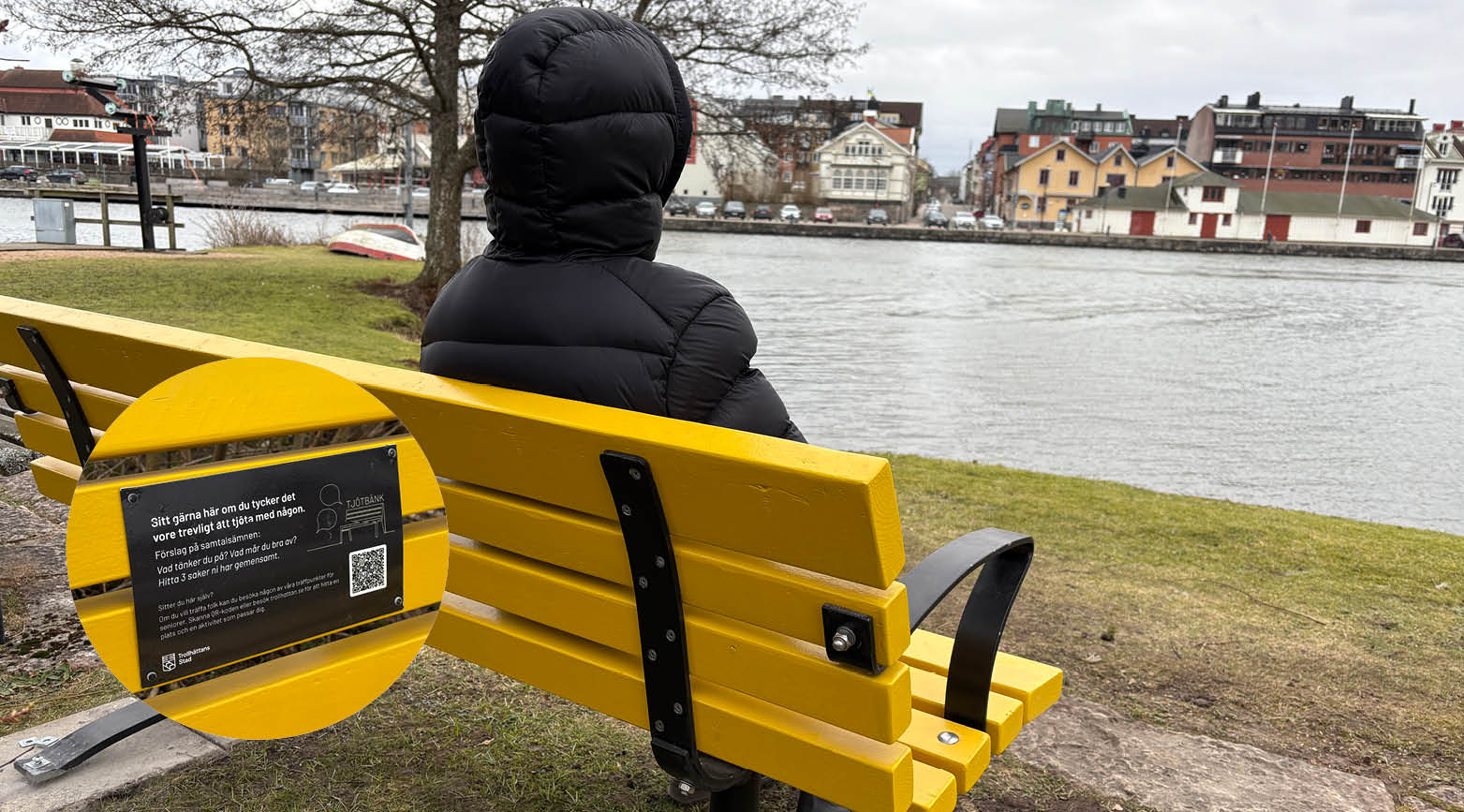 Kvinna som sitter på gul bänk och tittar ut över Trollhätte kanal